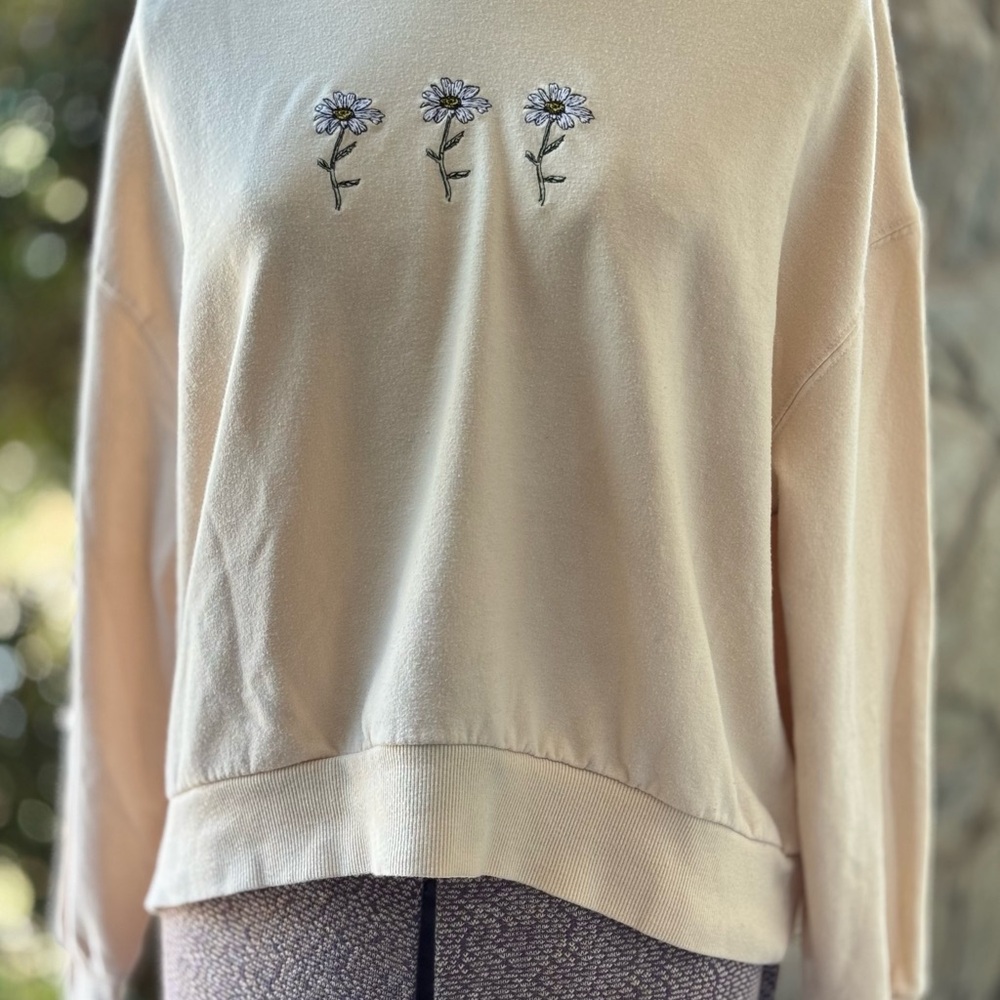 Rebellious One Cream Pullover with Floral Daisy Accents